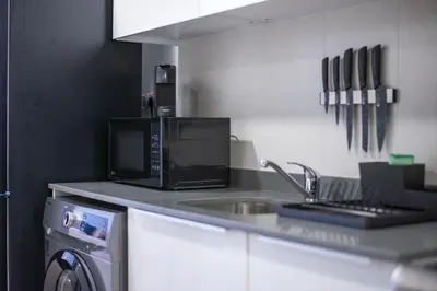 a kitchen with a microwave and a sink at Spectacular Views of Dubai Skyline in Dubai