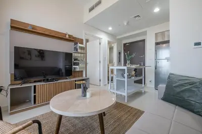 a living room with a table and a couch at City View I 1 Bedroom Apartment I Golf Vita, Damac Hills in Dubai