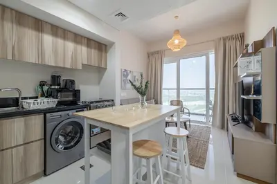a kitchen with a counter and a dishwasher at City View I 1 Bedroom Apartment I Golf Vita, Damac Hills in Dubai