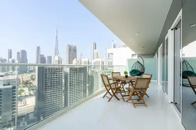 a balcony with a table and chairs and a view of the city at Gala Guests - Marasi Drive City View Apartments in Dubai