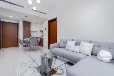a living room with a couch and a table at Gala Guests - Marasi Drive City View Apartments in Dubai