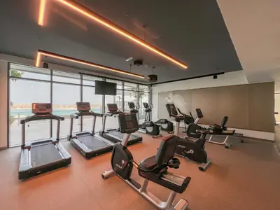 a gym with a bunch of treadmills and exercise bikes at Beachfront 2BR with Spectacular Sea and Palm Views - 17AB06 in Dubai