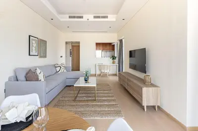a living room with a couch and a tv at Frank Porter - RP Heights in Dubai