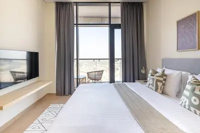a bedroom with a large bed and a large window at Frank Porter - RP Heights in Dubai
