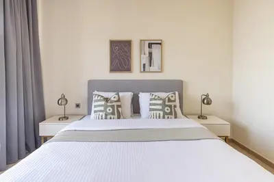 a bedroom with a large white bed with pillows at Frank Porter - RP Heights in Dubai