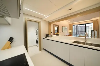 a kitchen with a sink and a washing machine at Cheval Maison - The Palm in Dubai