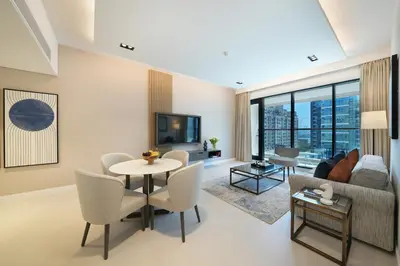 a living room with a couch and a table at Cheval Maison - The Palm in Dubai