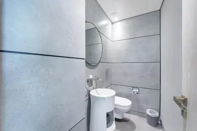 a bathroom with a white toilet and a sink at Beautiful, Stylish and Peaceful 1BD in JVC in Dubai