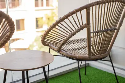 a chair and a table on a balcony at Beautiful, Stylish and Peaceful 1BD in JVC in Dubai