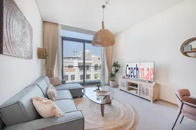 a living room with a couch and a table at Beautiful, Stylish and Peaceful 1BD in JVC in Dubai