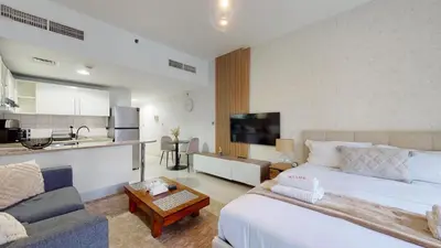a hotel room with a large bed and a kitchen at DA84 - Chic Studio in Dubai Arch Tower in Dubai