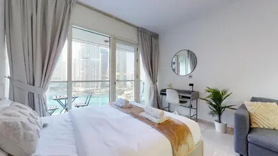 a bedroom with a large bed and a large window at DA84 - Chic Studio in Dubai Arch Tower in Dubai