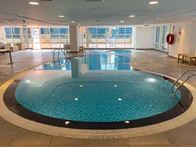 a large pool in the middle of a building at DA84 - Chic Studio in Dubai Arch Tower in Dubai