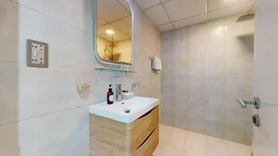 a bathroom with a sink and a mirror at DA84 - Chic Studio in Dubai Arch Tower in Dubai