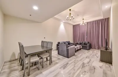 a dining room with a table and a couch at Grand Stay Holiday Homes Al Jaddaf in Dubai