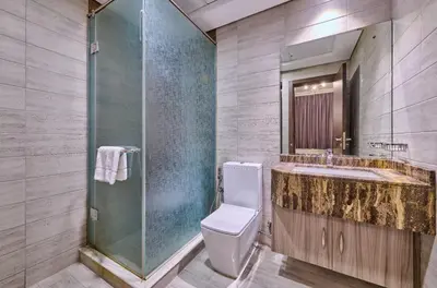 a bathroom with a toilet and a sink and a shower at Grand Stay Holiday Homes Al Jaddaf in Dubai