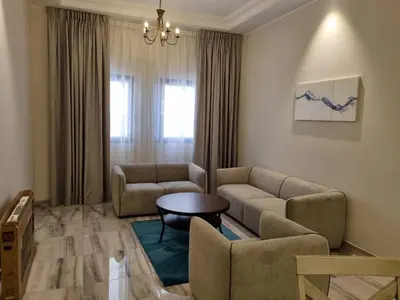 a living room with a couch and a table at Grand Stay Holiday Homes Al Jaddaf in Dubai