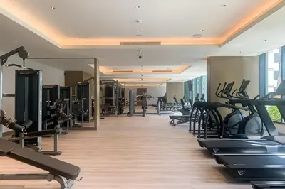 a gym with a lot of treadmills and machines at Frank Porter - One Park Avenue in Dubai