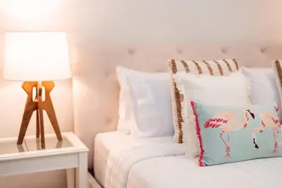 a bedroom with a bed with a lamp and a pillow at prime retreats - beach vista Emaar in Dubai