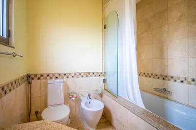 a bathroom with a toilet and a sink and a tub at Orion in Dubai