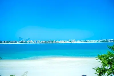 a view of a beach with a city in the background at Orion in Dubai