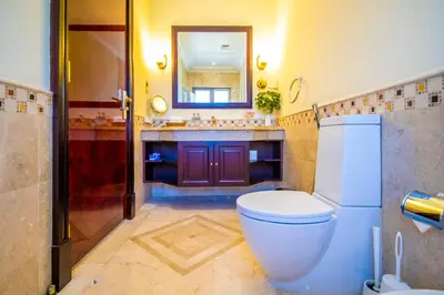 a bathroom with a toilet and a sink and a mirror at Orion in Dubai