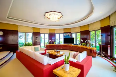 a living room with a red couch and a tv at Orion in Dubai