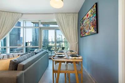 a living room with a couch and a table at Maison Privee - Balinese Style Apt in the Heart of Downtown Dubai in Dubai