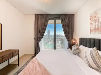 a bedroom with a bed and a large window at Modern 3BR in Marina, Sea View Next to Bluewater - 28AB02 in Dubai