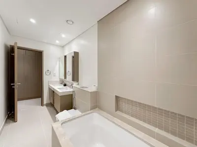a white bathroom with a sink and a mirror at Modern 3BR in Marina, Sea View Next to Bluewater - 28AB02 in Dubai