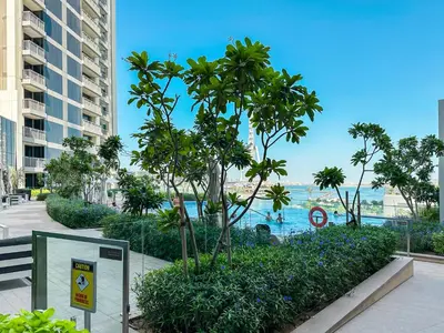 a view of a resort with a pool and palm trees at Modern 3BR in Marina, Sea View Next to Bluewater - 28AB02 in Dubai