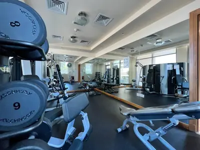 a gym with several treadmills and cardio machines at Vacay Lettings - Iris blue spectacular Marina view Apartment in Dubai