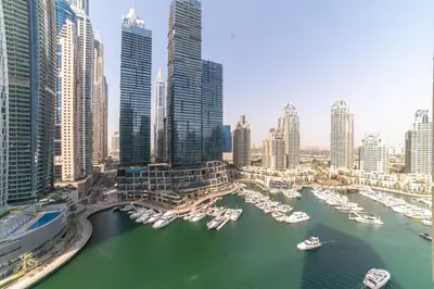 a view of a city with boats in a harbor at Vacay Lettings - Iris blue spectacular Marina view Apartment in Dubai