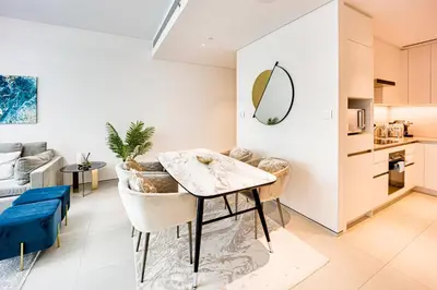 a kitchen and living room with a table and chairs at Spacious 1BD apartment in Address Beach Residence in Dubai