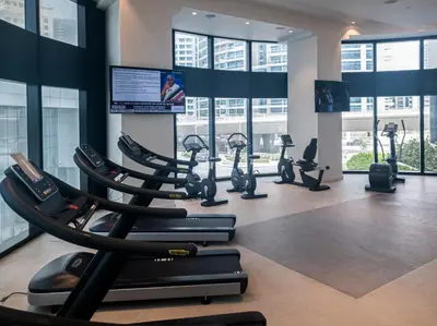 a gym with treadmills and elliptical machines at Spacious 1BD apartment in Address Beach Residence in Dubai