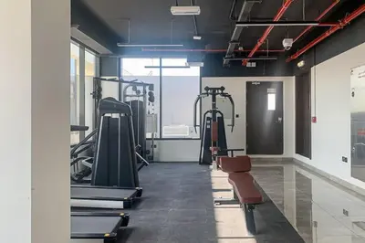 a gym with treadmills and ellipticals in a room at Frank Porter - Majestique 1 in Dubai