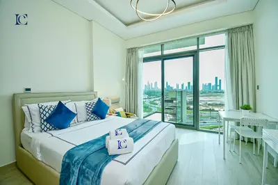 a bedroom with a large bed and a large window at Luxury Escapes - Brand New Studio with View - Azizi Farhad Jaddaf in Dubai