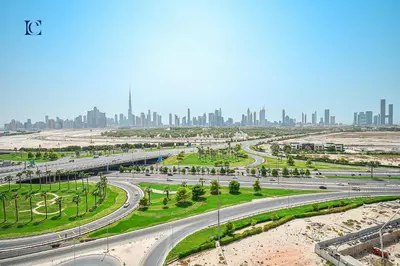 a highway with a city skyline in the background at Luxury Escapes - Brand New Studio with View - Azizi Farhad Jaddaf in Dubai