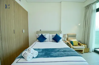 a bedroom with a large bed with towels on it at Luxury Escapes - Brand New Studio with View - Azizi Farhad Jaddaf in Dubai
