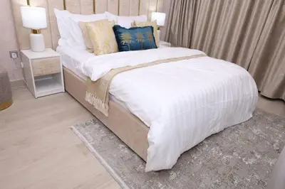 a bedroom with a large bed with white sheets and pillows at Superb Studio by The Creek view in Dubai