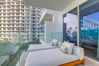 a bedroom with a white bed and a large window at Daniels Five Palm Sea View 2BR with Maids Room in Dubai