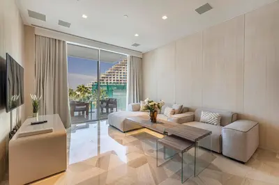 a living room with a couch and a table at Daniels Five Palm Sea View 2BR with Maids Room in Dubai