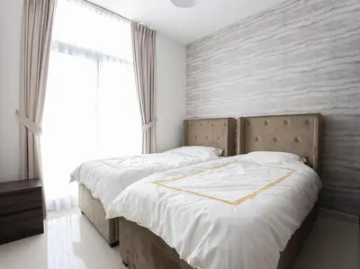 a bedroom with two beds and a large window at Corner 3Bedroom Townhouse in Avencia Cluster DH2 in Dubai
