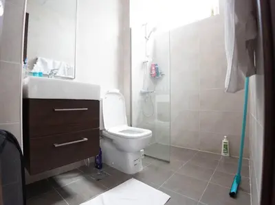a bathroom with a toilet and a glass shower at Corner 3Bedroom Townhouse in Avencia Cluster DH2 in Dubai