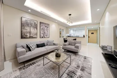 a living room with a couch and a table at Paramount Midtown Deluxe 1 BR Apartment with Full Burj-Khalifa View in Dubai