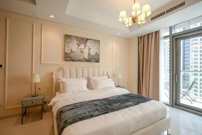 a bedroom with a large bed and a large window at Infinity Pool & Burj Khalifa View l Luxe Paramount in Dubai