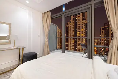 a bedroom with a bed and a large window at Infinity Pool & Burj Khalifa View l Luxe Paramount in Dubai