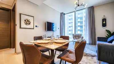 a dining room with a table and chairs at STAY BY LATINEM Luxury 1BR Holiday Home CV A2304 near Burj Khalifa in Dubai