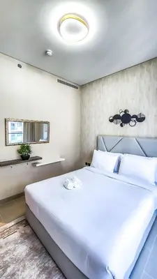a bedroom with a large white bed in a room at STAY BY LATINEM Luxury 1BR Holiday Home CV A2304 near Burj Khalifa in Dubai