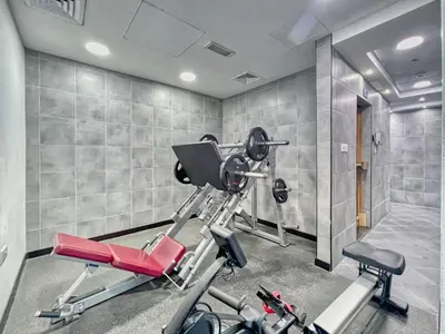 a gym with a treadmill and two exercise bikes at The Smart Concierge - DEC Tower in Dubai